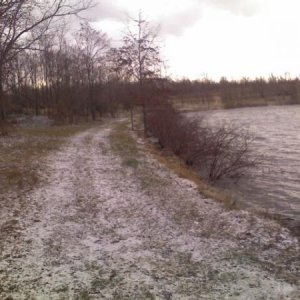 Snowy path by lake