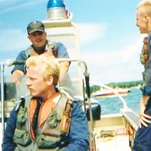 Much younger me Driving , Eric Schuunder foreground, Chuck Webb to right on boat safety patrol in Lake Huron.