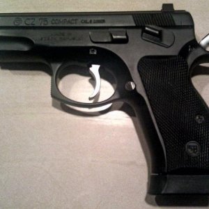 CZ 75 Compact with rubber grips, Trijicon night sights and a Mecgar 16 round magazine using an SP01 baseplate.