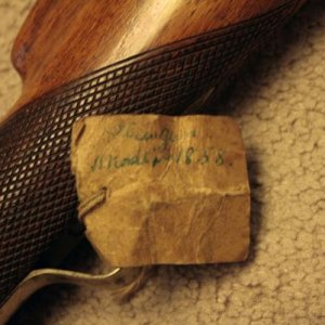 musket label says "Gun Made in 1858." there is also some text in pencil but it isn't possible to read.